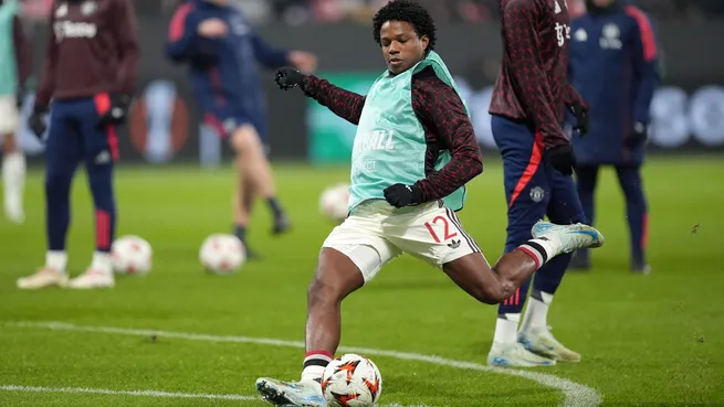 Tyrell Malacia warms up before the Europa League match